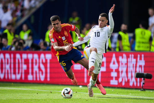 Rodrigo Hernandez of Spain and Jamal Musiala of Germany