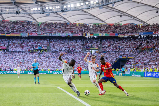Antonio Rüdiger and Joshua Kimmich of Germany compete for the ball with Nicholas Williams of Spain