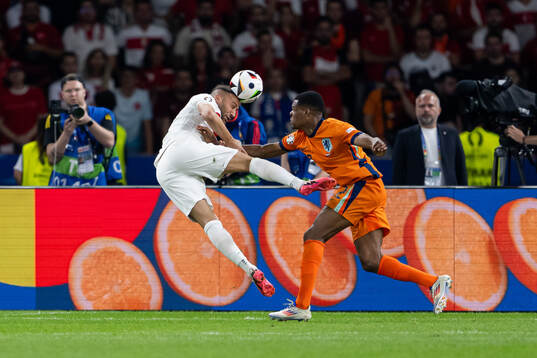 Cenk Tosun of Turkey and Denzel Dumfries of Netherlands during the UEFA Euro 2024 Football Championship quarterfinal between Netherlands and Turkey on July 6, 2024 in Berlin. 
