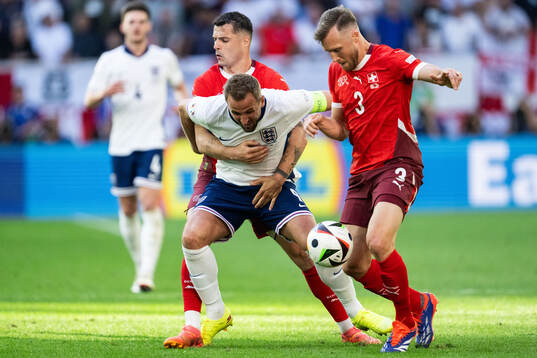 Granit Xhaka and Silvan Widmer of Switzerland against Harry