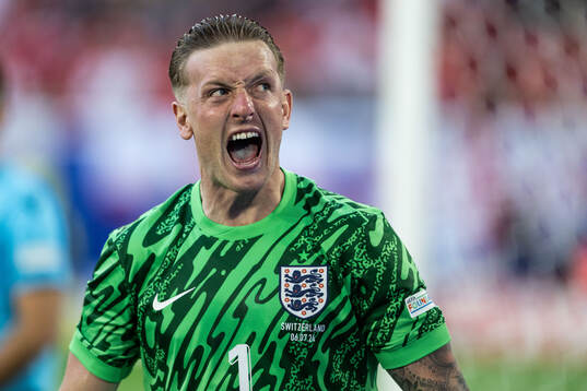 Goalkeeper Jordan Pickford of England celebrates after saving a penalty