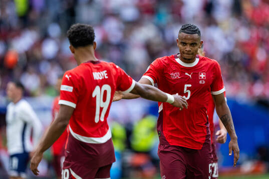Dan Ndoye and Manuel Akanji of Switzerland