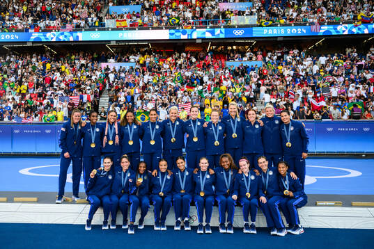 Players of USA celebrate with their gold medals after the women’s football final between Brazil and USA
