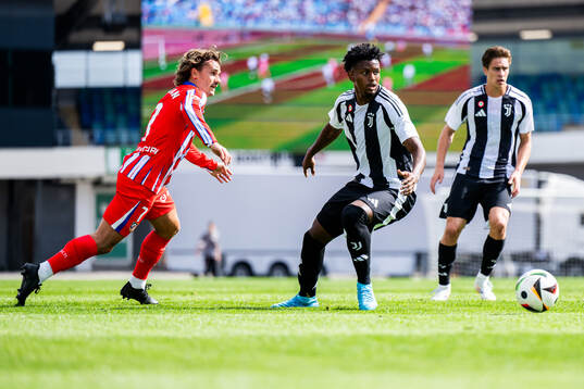 Antoine Griezmann of Atletico Madrid and Juan Cabal Murillo of Juventus