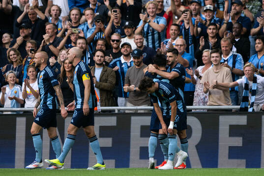 Besard Sabovic of Djurgården celebrates with team mates after 1-0