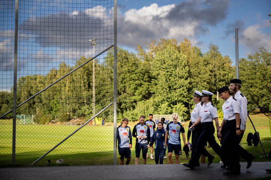 Members of military in front of Sebastian Nanasi,
