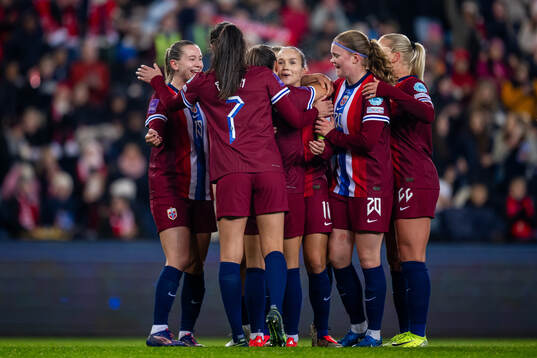 Guro Reiten of Norway celebrates with Elisabeth Terland, Ingrid Syrstad Engen and teammates after scoring 8-0