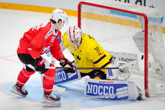 Theo Rochette of Switzerland and goaltender Jacob Johansson