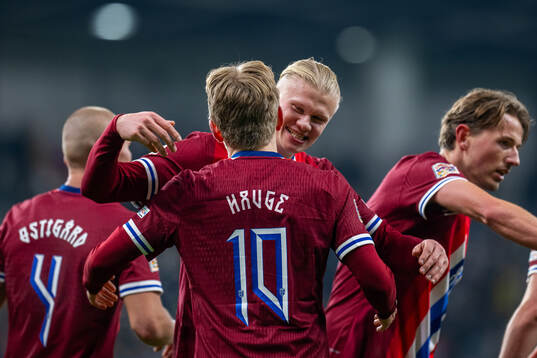 Jens Petter Hauge of Norway celebrates with teammate Erling Braut Haaland after scoring 1-4