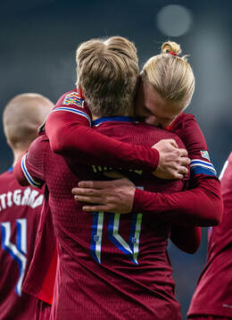 Jens Petter Hauge of Norway celebrates with teammate Erling Braut Haaland after scoring 1-4