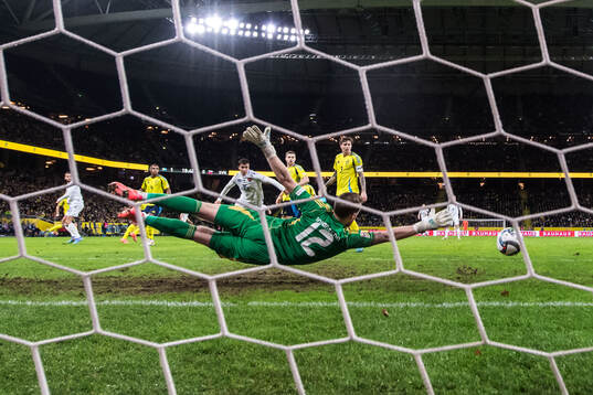 David Hancko of Slovakia (not in picture) scores 1-1 behind
