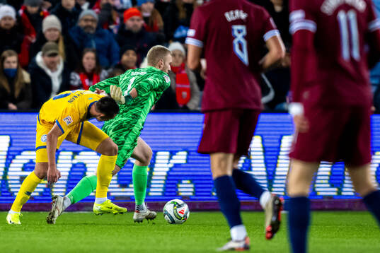 Aibar Zhaksylykov of Kazakhstan and goalkeeper Egil Selvik of Norway