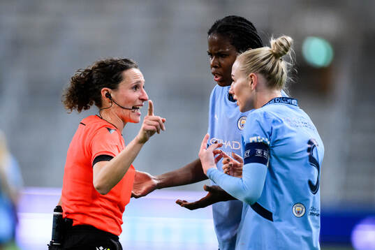 Referee Silvia Gasperotti and Alex Greenwood and Khadija