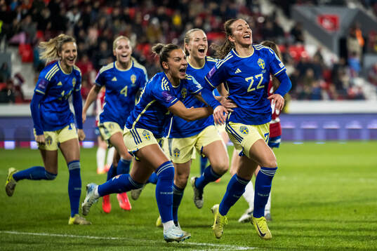 Johanna Rytting Kaneryd, Magdalena Eriksson, and Rusul Rosa Kafaji of Sweden celebrate the 2-0 goal
