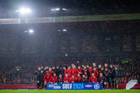 Players and staff of Brann celebrate