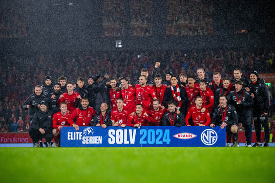 Players and staff of Brann celebrate