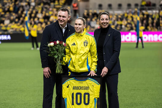 Jonna Andersson of Sweden is celebrated for 100 games with Head of football Kim Källström and General secretary Andrea Möllerberg of the Swedish Football Association ahead of the UEFA Women's Euro Qualifier play-off football match between Sweden and Serbia on December 3, 2024 in Stockholm. 