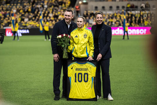 Jonna Andersson of Sweden is celebrated for 100 games with Head of football Kim Källström and General secretary Andrea Möllerberg of the Swedish Football Association ahead of the UEFA Women's Euro Qualifier play-off football match between Sweden and Serbia on December 3, 2024 in Stockholm. 