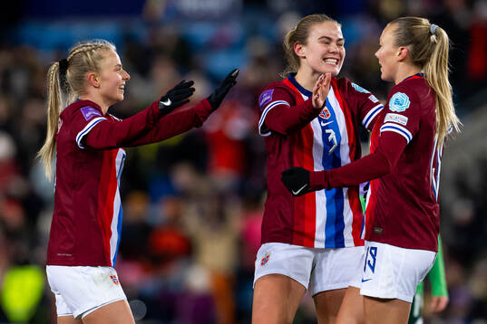 Synne Sofie Kinden Jensen of Norway celebrates with teammates Emilie Woldvik and Marthine Østenstad after scoring 3-0