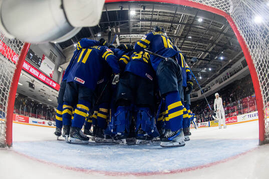 Goaltender Melker Thelin of Sweden celebrates with team