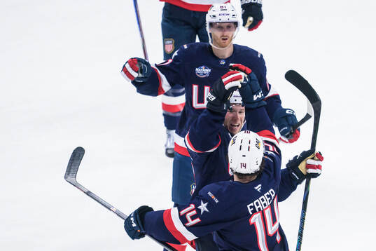 Brock Faber, Matt Boldy and Kyle Connor of USA celebrate