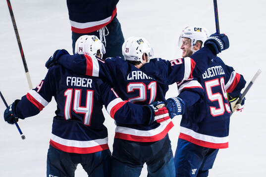 Brock Faber, Dylan Larkin and Jake Guentzel of USA