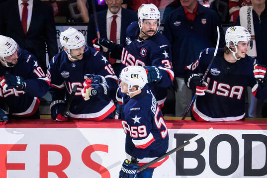 Jake Guentzel of USA celebrates with teammates