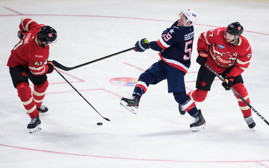Mark Stone and Connor McDavid of Canada in action against