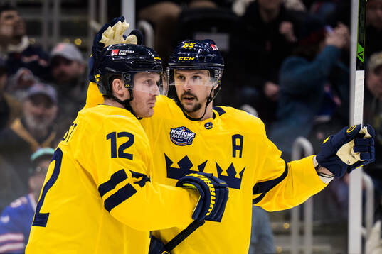 Gustav Nyquist and Erik Karlsson of Sweden celebrate the
