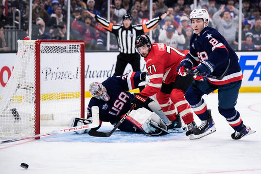 Goaltender Connor Hellebuyck and Zach Werenski of USA are