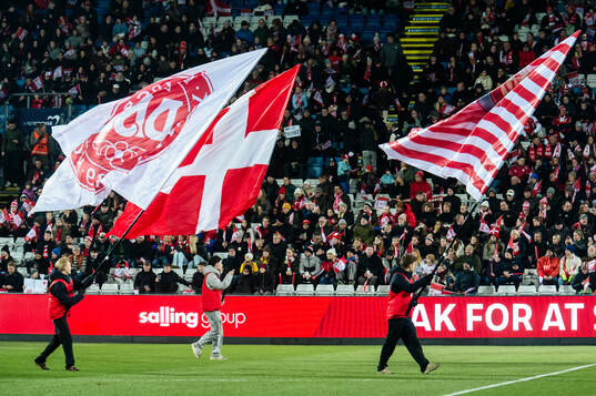 Flag bearers with Danish flags ahead of the UEFA Women's Nations League football match between Denmark and Sweden on February 21, 2025 in Odense. 