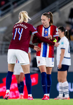 Ada Hegerberg of Norway gives the captains’ armband to Caroline Graham Hansen