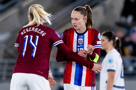 Ada Hegerberg of Norway gives the captains’ armband to Caroline Graham Hansen