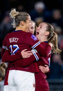 Elisabeth Terland of Norway celebrates with teammates