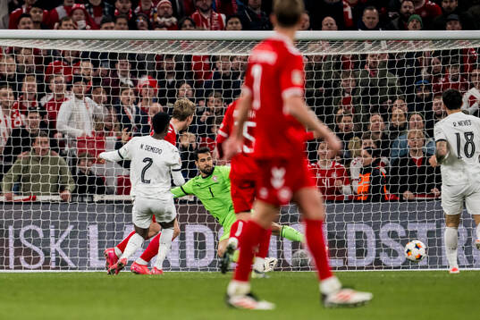 Rasmus Højlund of Denmark scores 1-0 behind goalkeeper