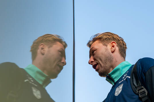 Goalkeeper Mathias Dyngeland of the Norwegian national football team enters the team bus arriving at Chisinau International Airport