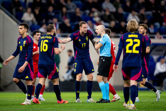 Jesper Karlström and Gustaf Nilsson of Sweden with referee