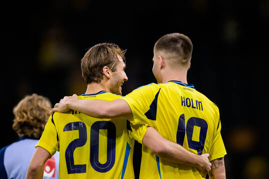 Benjamin Nygren and Emil Holm of Sweden hug each other