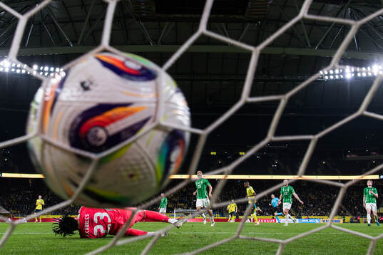 Alexander Isak of Sweden celebrates after scoring the 4-0 goal behind goalkeeper Pierce Charles of Northern Ireland