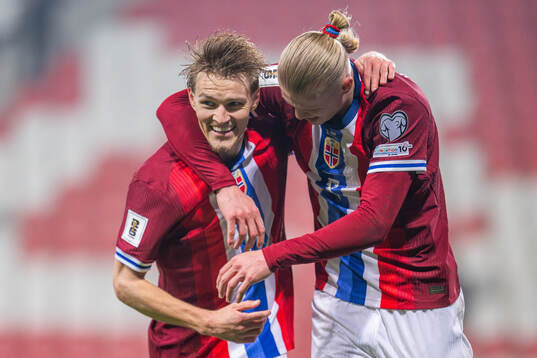 Erling Braut Haaland of Norway celebrates with teammate Martin Ødegaard after scoring 1-4