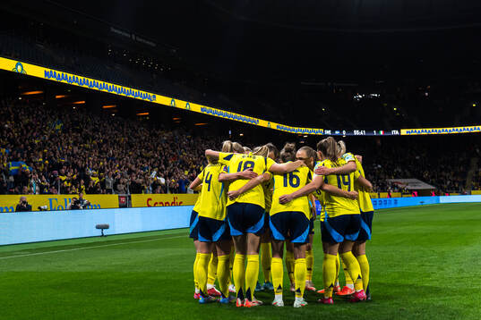 Kosovare Asllani of Sweden celebrates with team mates after scoring 1-1