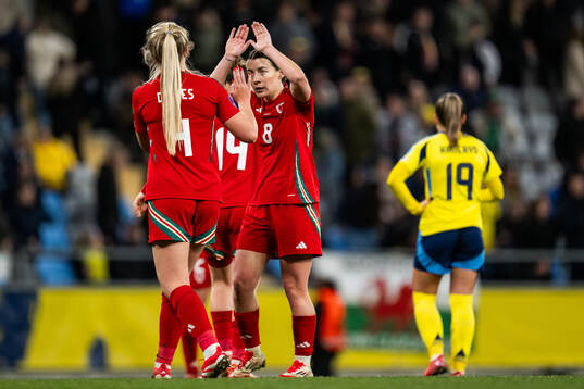Mayzee Davies and Angharad James of Wales celebrate