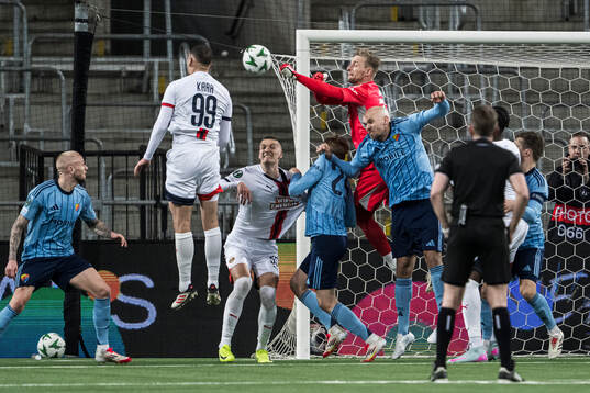 Goalkeeper Jacob Rinne of Djurgården and Ercan Kara and
