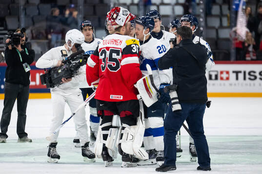 Goaltender Atte Tolvanen of Austria with Eeli Tolvanen of