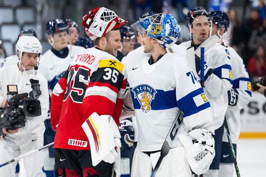 Goaltender Atte Tolvanen of Austria with goaltender Juuse
