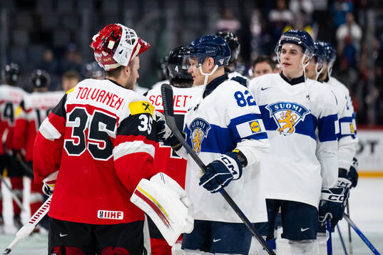 Goaltender Atte Tolvanen of Austria with Harri Pesonen of