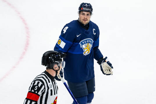Mikko Lehtonen of Finland in discussion with referee Andre