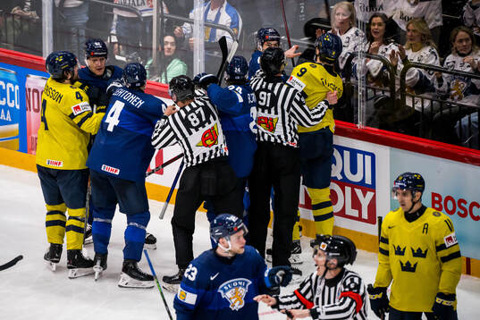 linesman Shane Gustafson and linesman Jake Davis intervene