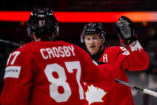 Sidney Crosby and Nathan MacKinnon of Canada celebrates