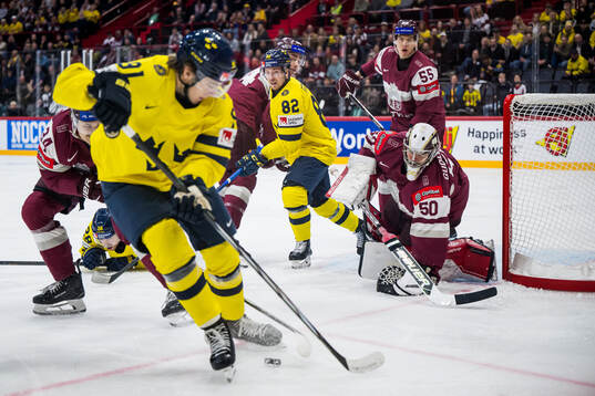 Jesper Frödén of Sweden and goalkeeper Kristers